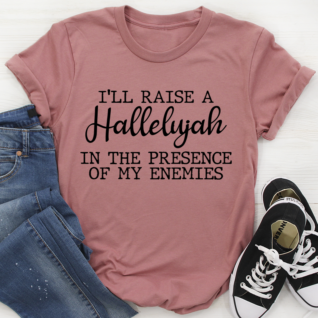 A black t-shirt featuring the phrase 'I'll Raise A Halleluyah In The Presence Of My Enemies' in stylish typography, made from soft cotton.